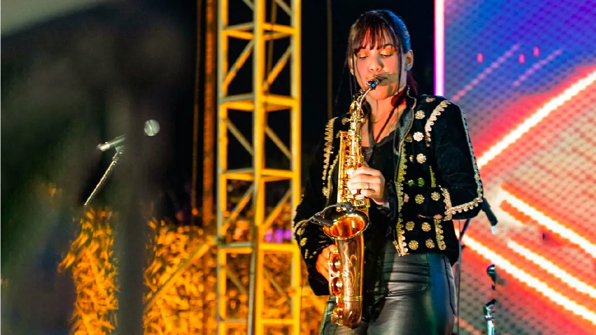 Live saxophonist performing on a professionally equipped event stage